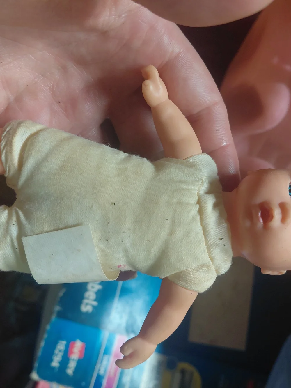 a vintage 1997 Corolle mini baby doll featuring blue eyes and a soft body.